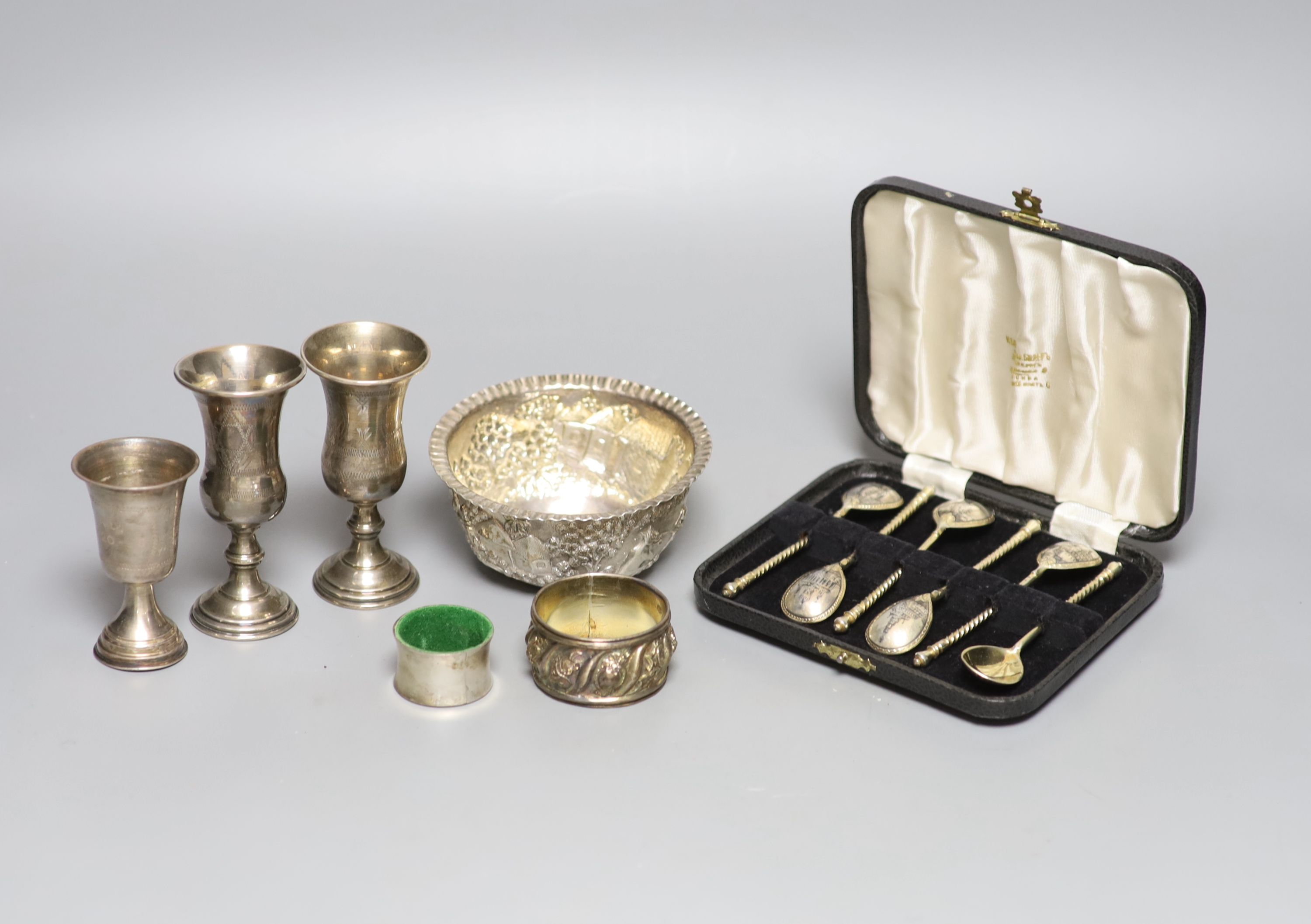A cased set of six late 19th century Russian 84 zolotnik and niello teaspoons, three sterling kiddush cups, a French white metal napkin ring, a small sterling napkin ring and an Indian white metal bowl.